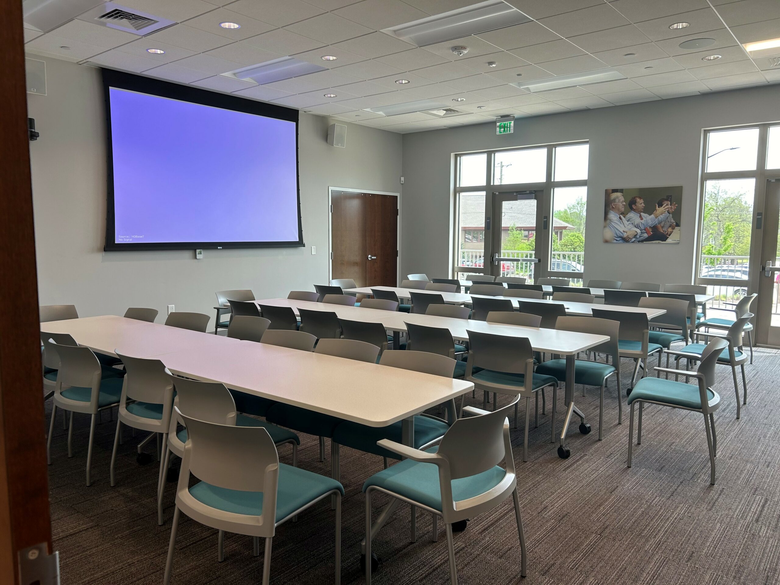 classroom style layout for a meeting room with tables and chairs set for 32