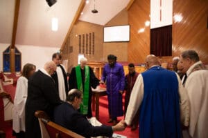 people holding hands in a prayer circle